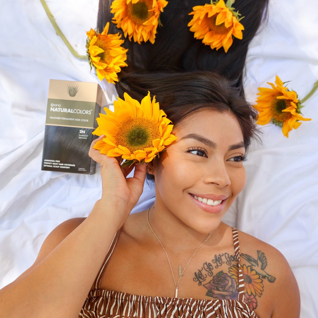 Smiling model with sunflower and natural hair color product